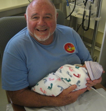 New Grandpa Mike Brennan with one of the twins born July 31, 2009